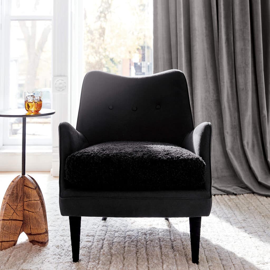 Small side table next to a boucle chair