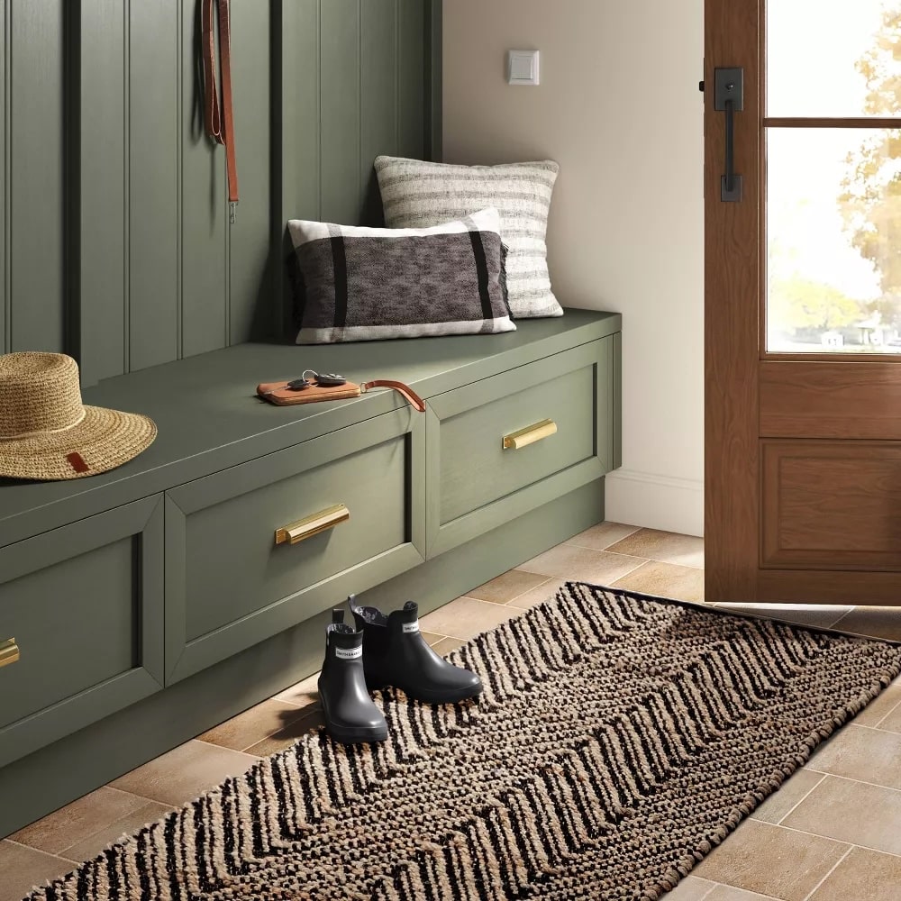 Cotton and jute chevron runner from Target sits at the front door with boots on top.