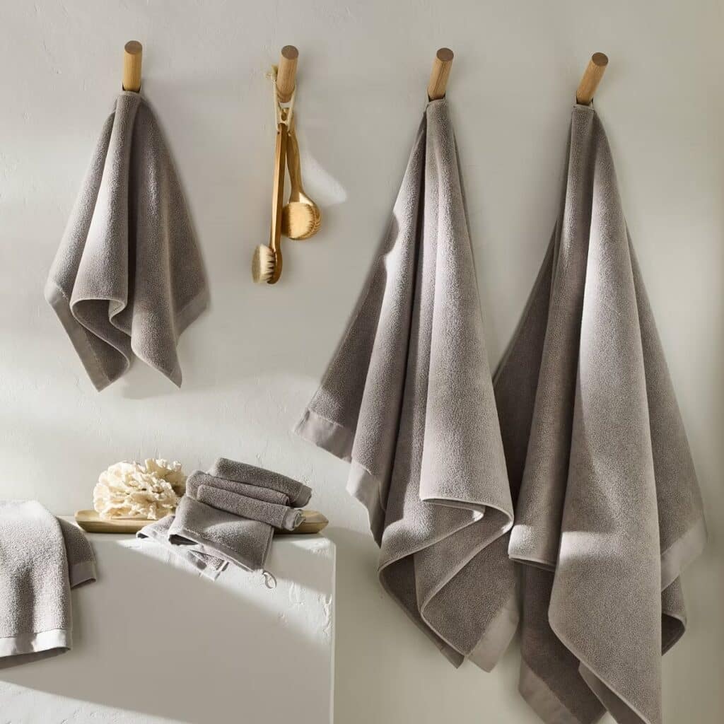 A gray Casaluna towel set from Target hanging on a bathroom wall.