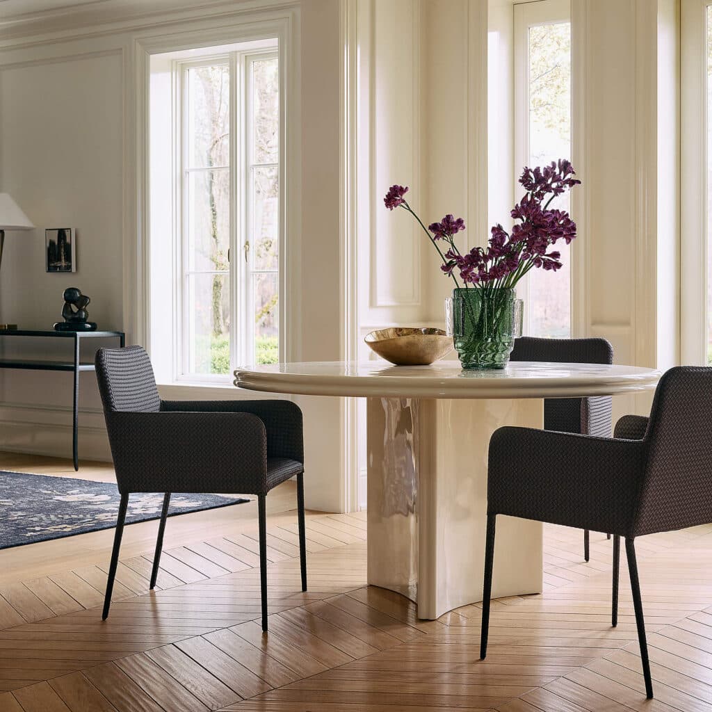 Duke sienna brown vegan leather dining chairs around a table from CB2 are a budget-friendly dining chair option.