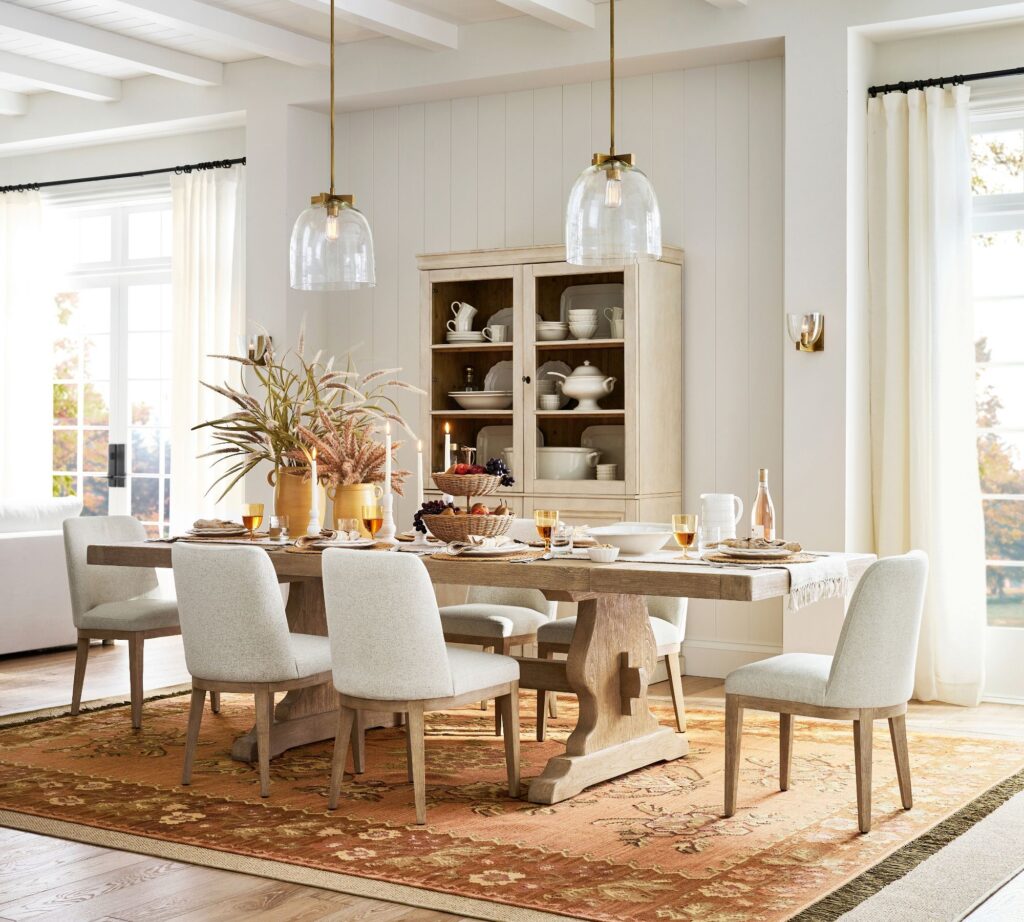 Performance fabric upholstered dining chairs around a wod table from Pottery Barn from our yop interior design resolutions for 2026 guide.