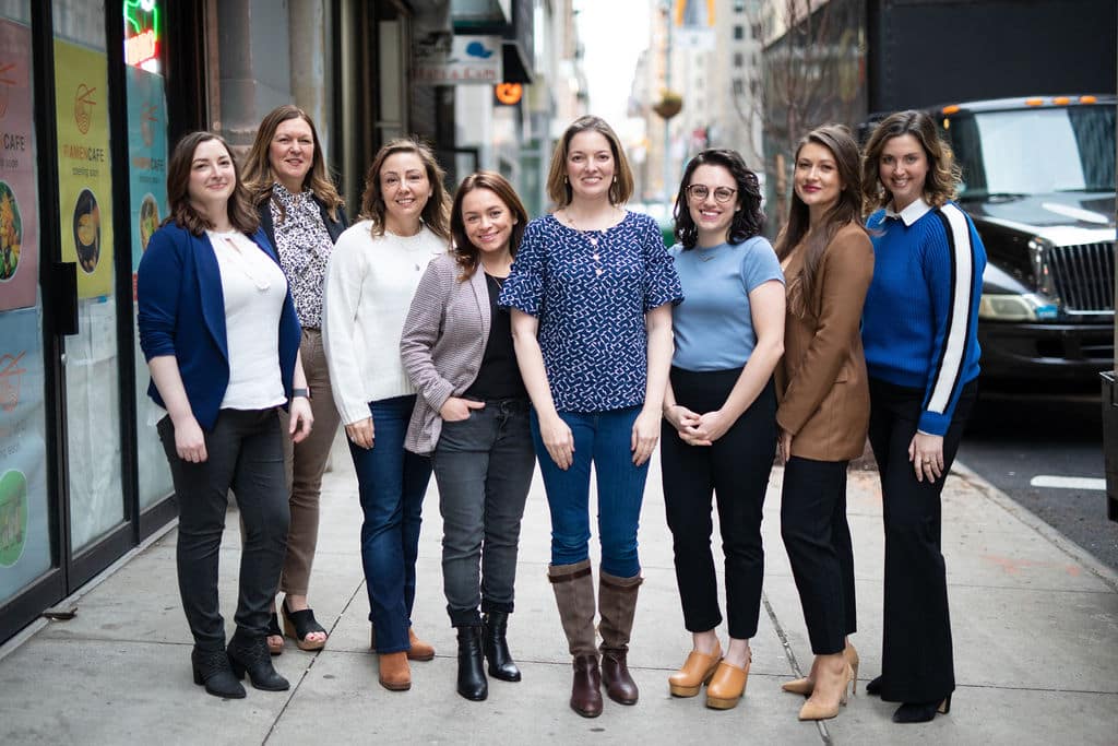 The Uploft Interior Design Team posing on the sidewalk in New York City.