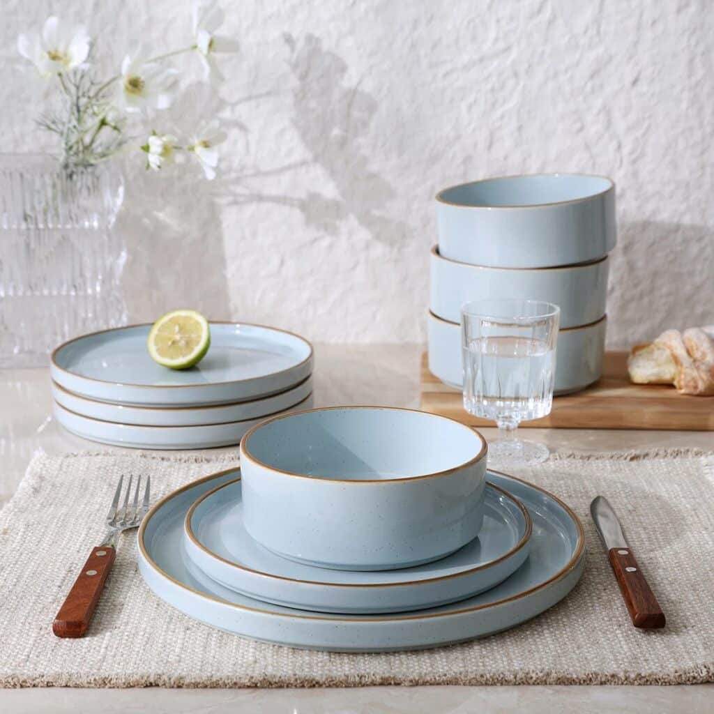Blue dinnerware with light brown rims on a white placemat from our affordable kitchenware and serveware guide.
