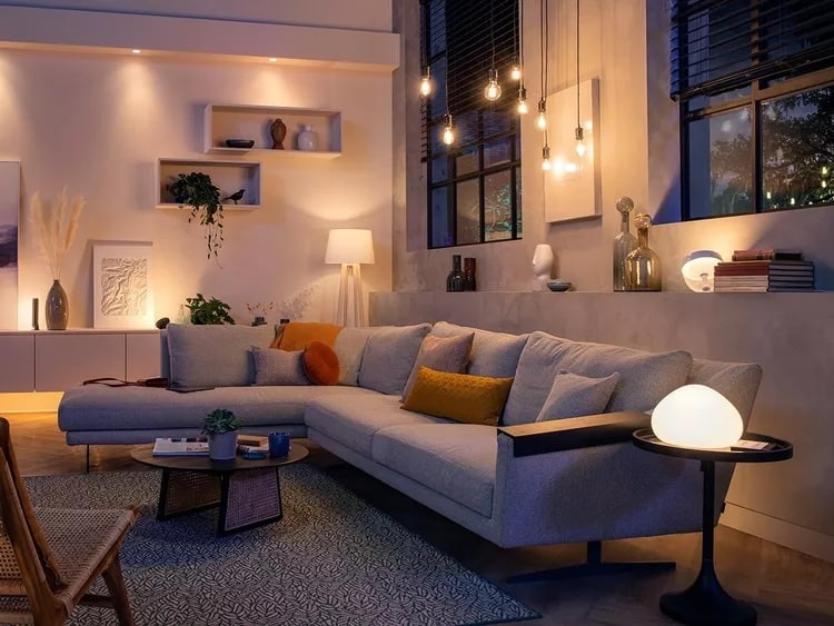 Living room seating area with table lamps and floor lamps creating soft, comfortable pools of light.