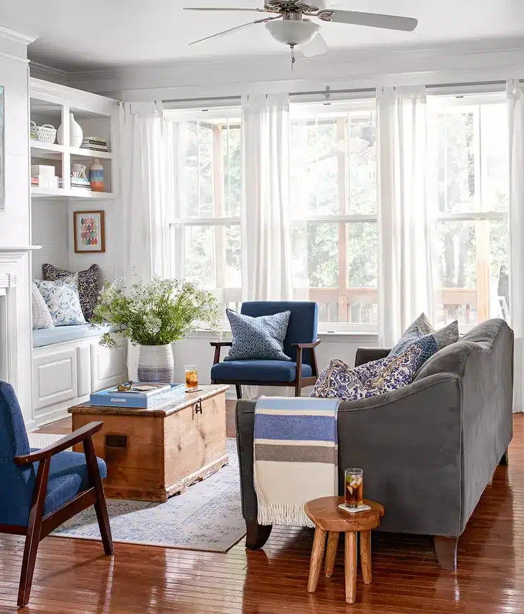 Living room with overhead lighting but limited lamps creating uneven light.