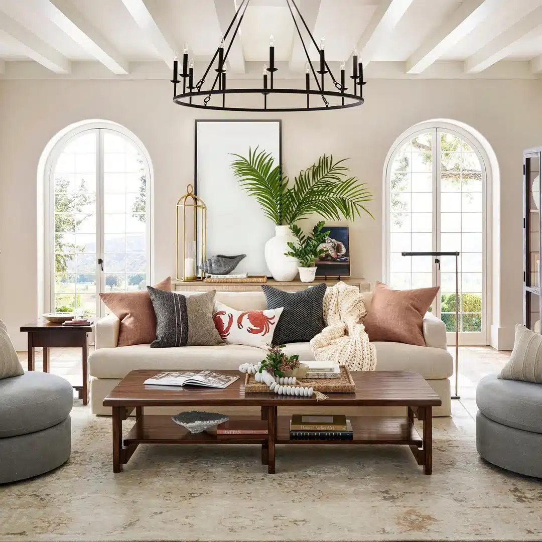 Living room with layered seating, balanced lighting, and wall color that contrasts with white trim.