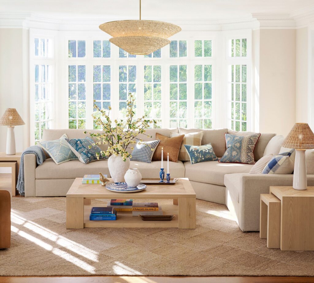 Neutral sofa styled with layered throw pillows and blankets for flexible, easy color updates.