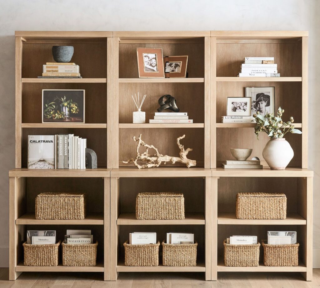 Bookcase styled with stacked books and decor creating visual balance.
