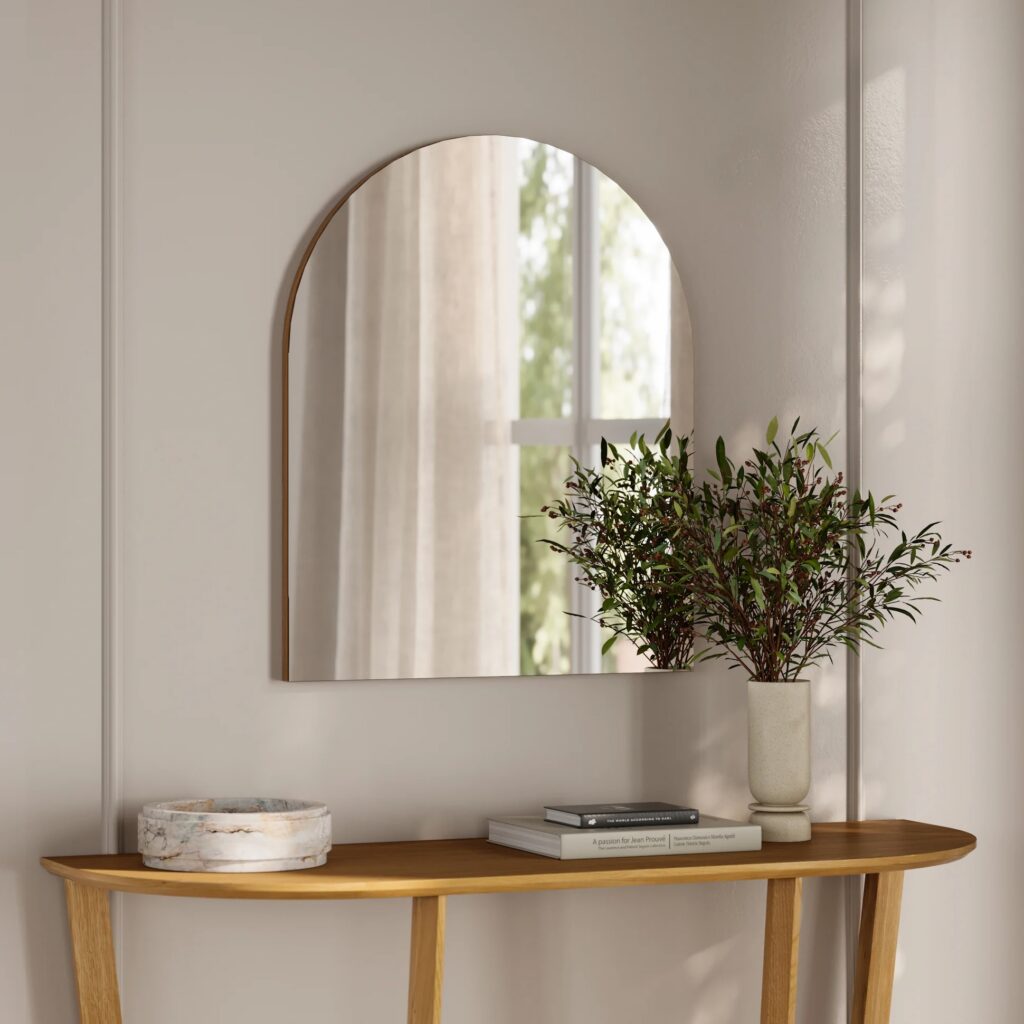 Entryway styled with minimal decor and a mirror creating a balanced and intentional space.