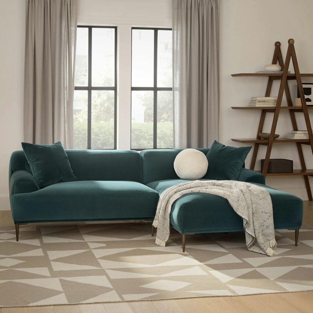 Jewel-toned sofa used as a focal point in a balanced living room.