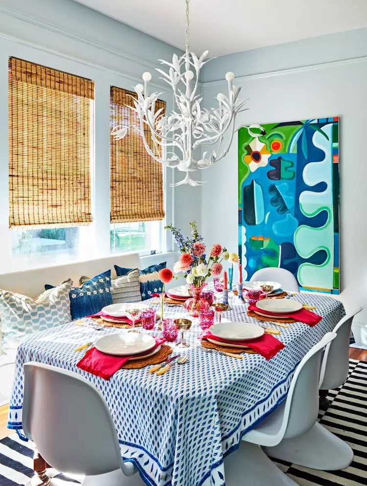 Dining room with one large statement artwork piece above a dining table.