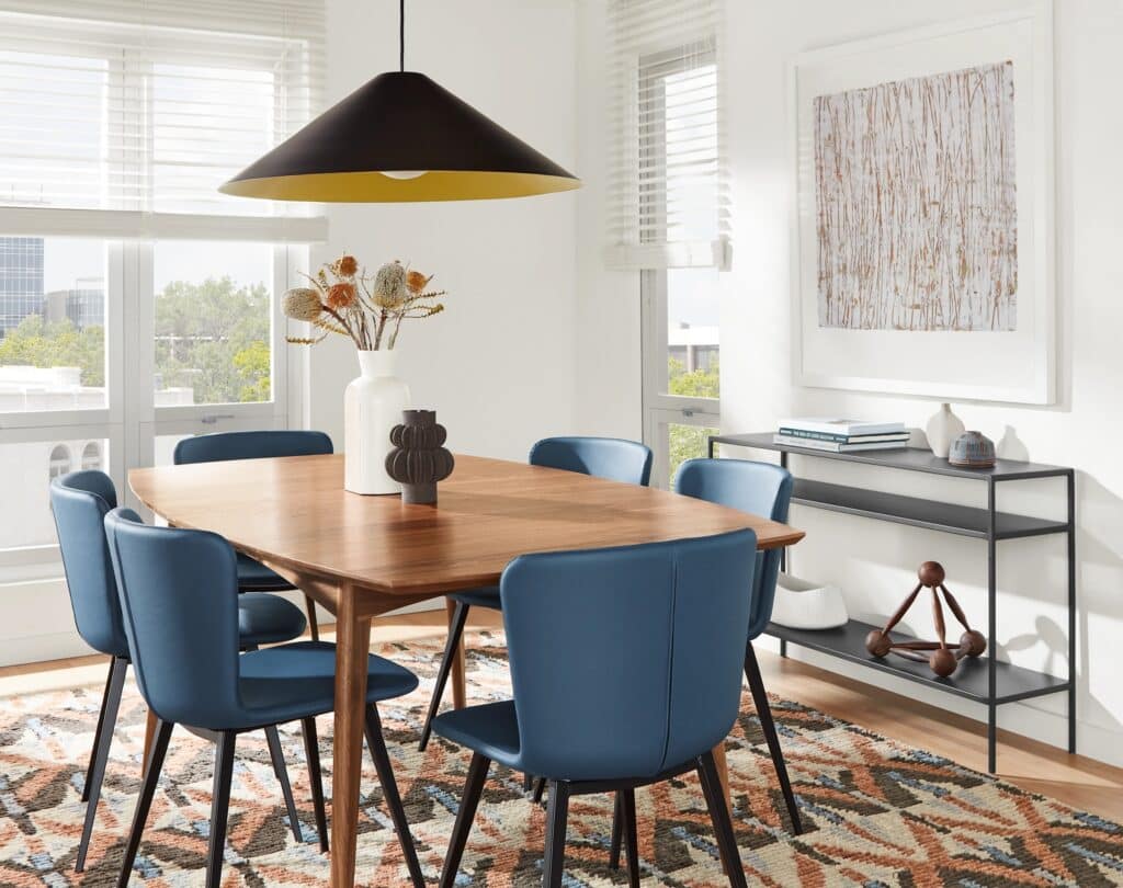 Dining room light fixture centered properly over a rectangular dining table.
