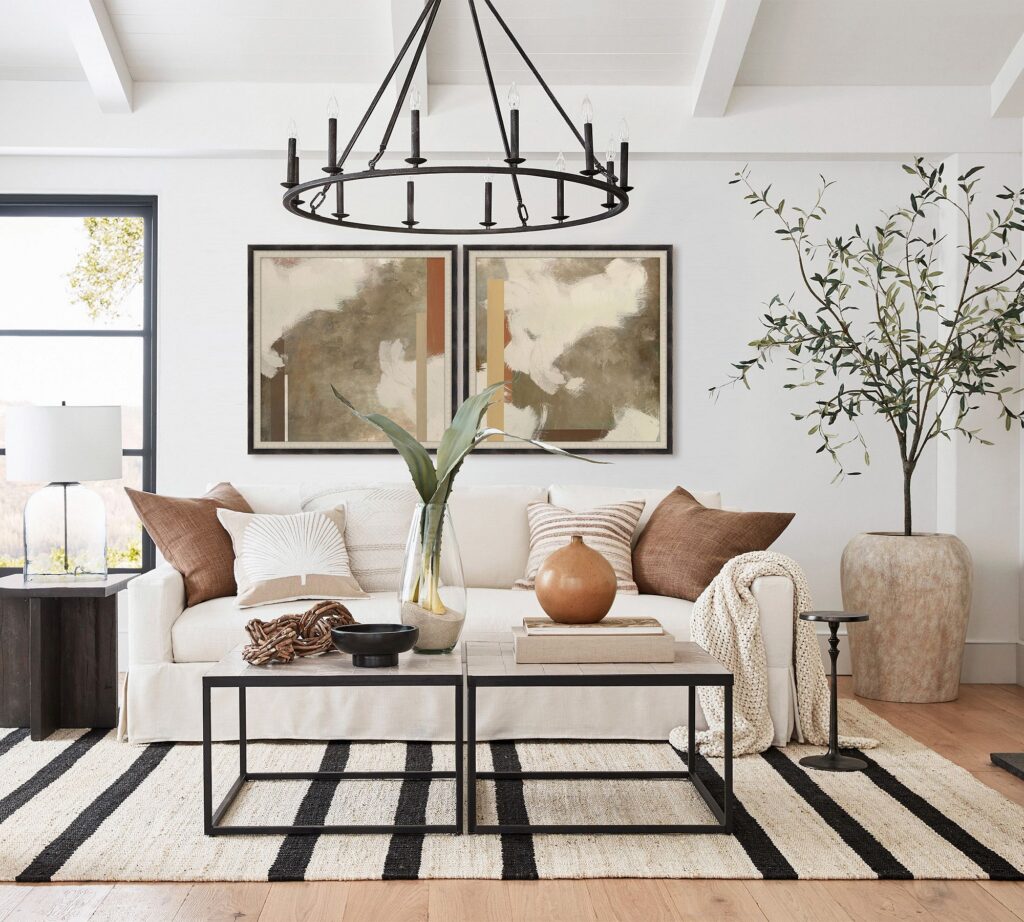 Oversized abstract artwork displayed above a neutral sofa in a modern living room.