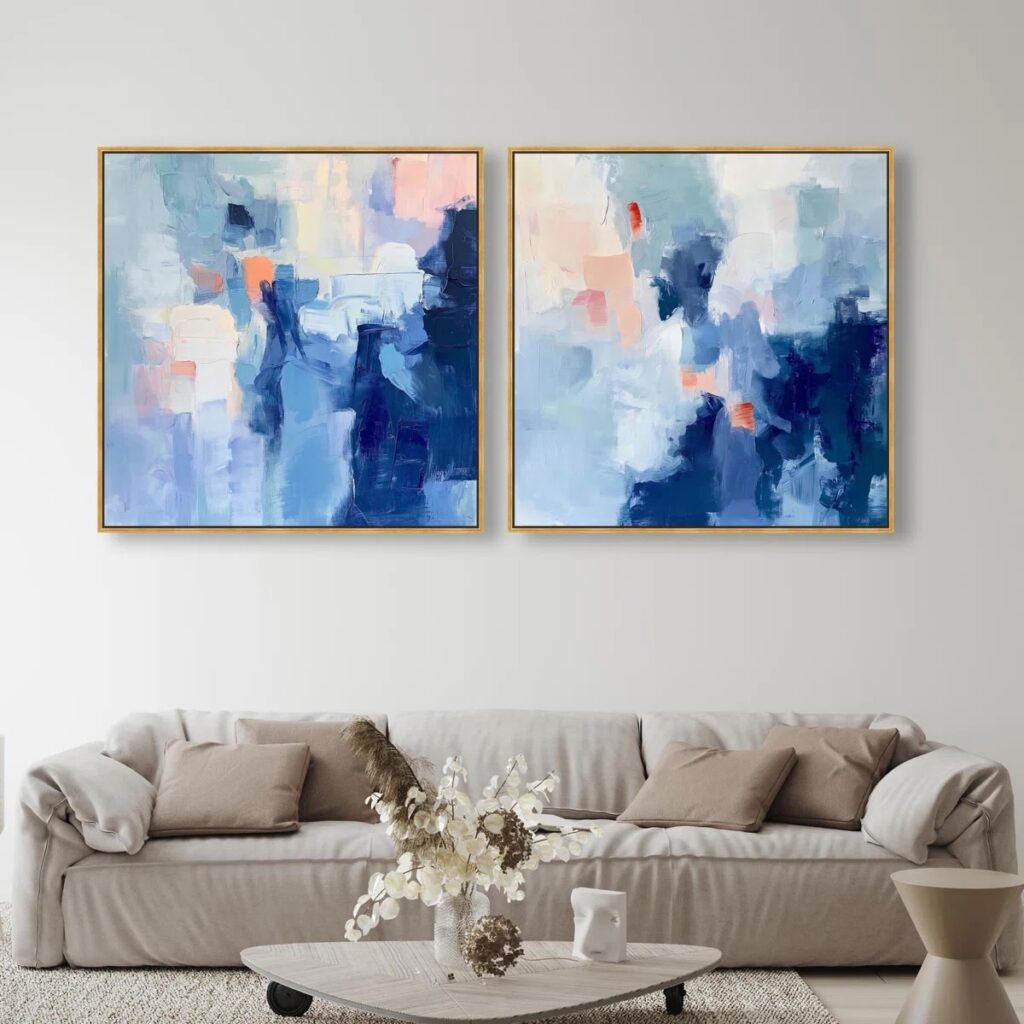 Large framed artwork properly scaled above a living room sofa.